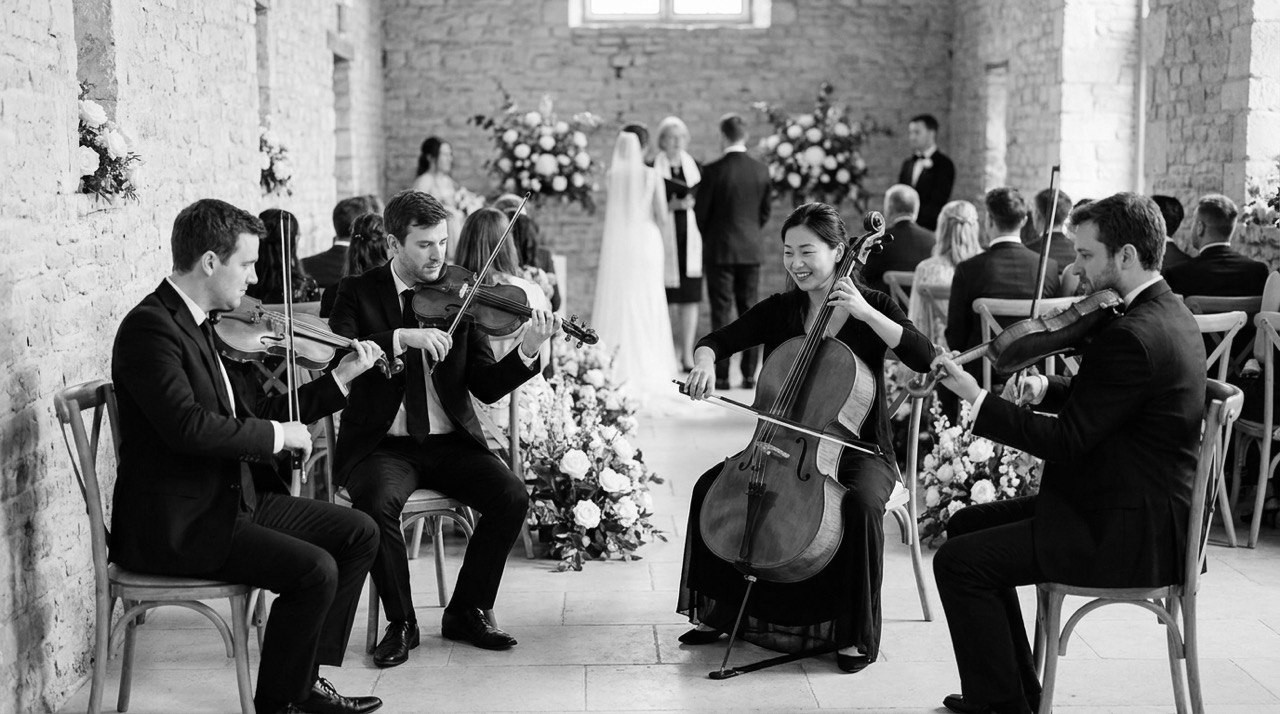 Live string quartet performing at a wedding ceremony